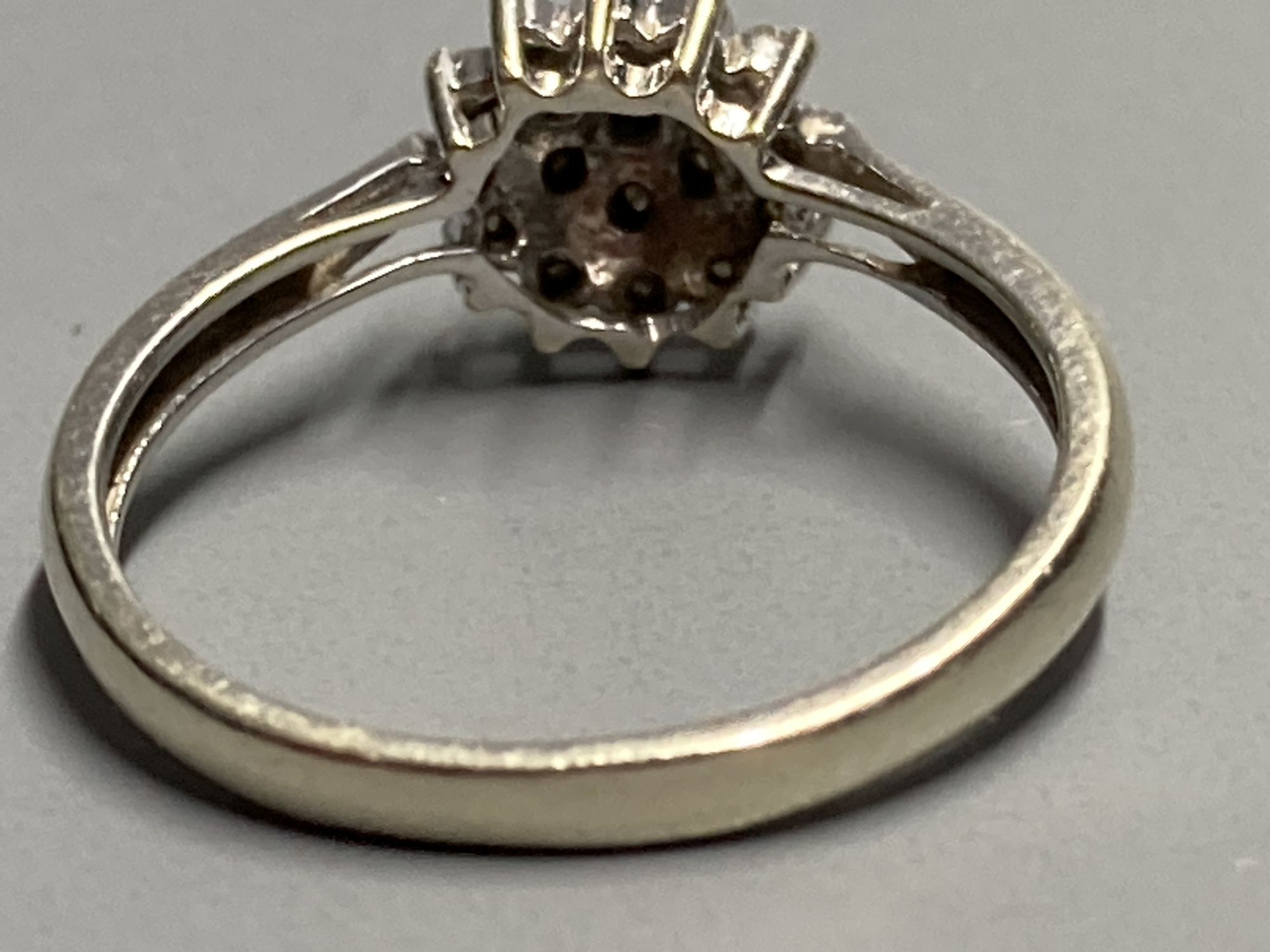 A modern 9ct white gold and diamond cluster ring, size M/N, gross 2 grams.